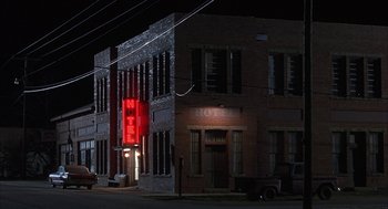 Movie still from “My Cousin Vinny” (1992), directed by Jonathan Lynn – A building that has been lit up at night; Extreme Wide shot, High angle