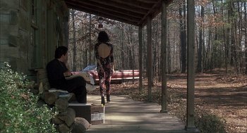 Movie still from “My Cousin Vinny” (1992), directed by Jonathan Lynn – A man and a woman sitting on a bench in the woods; Wide shot, Low angle