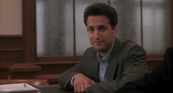 Movie still from “My Cousin Vinny” (1992), directed by Jonathan Lynn – A man sitting at a table in front of a mirror; Close Up shot, High angle