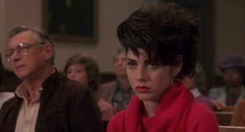 Movie still from “My Cousin Vinny” (1992), directed by Jonathan Lynn – A person wearing a red scarf; Close Up shot, Over the shoulder angle