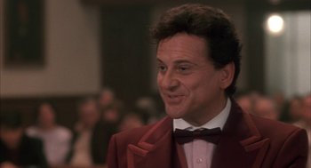 Movie still from “My Cousin Vinny” (1992), directed by Jonathan Lynn – A person wearing a suit and bow tie; Close Up shot, Low angle