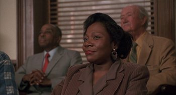Movie still from “My Cousin Vinny” (1992), directed by Jonathan Lynn – A group of people sitting in front of a window; Close Up shot, Low angle