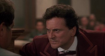 Movie still from “My Cousin Vinny” (1992), directed by Jonathan Lynn – A person wearing a suit and bow tie; Close Up shot, Low angle