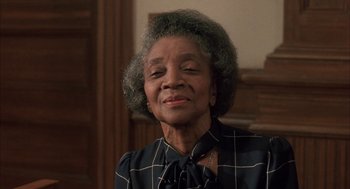 Movie still from “My Cousin Vinny” (1992), directed by Jonathan Lynn – An older woman is smiling for the camera; Close Up shot, Low angle