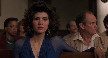 Movie still from “My Cousin Vinny” (1992), directed by Jonathan Lynn – A woman in a blue dress sitting next to a man in a brown suit; Close Up shot, Over the shoulder angle