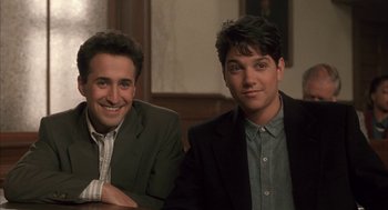 Movie still from “My Cousin Vinny” (1992), directed by Jonathan Lynn – Two young men sitting at a table in a room; Medium shot, High angle
