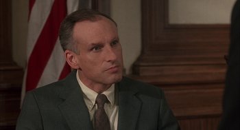 Movie still from “My Cousin Vinny” (1992), directed by Jonathan Lynn – A person wearing a suit and tie; Close Up shot, High angle