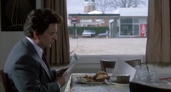 A man sitting at a table with food in front of him