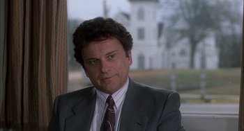 Movie still from “My Cousin Vinny” (1992), directed by Jonathan Lynn – A person wearing a suit and tie; Close Up shot, Over the shoulder angle