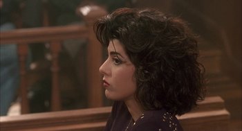 Movie still from “My Cousin Vinny” (1992), directed by Jonathan Lynn – A person sitting in front of a window; Close Up shot, High angle