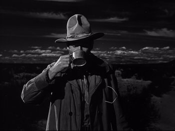 Movie still from “My Darling Clementine” (1946), directed by John Ford – A man in a hat drinking from a mug; Medium shot, Low angle