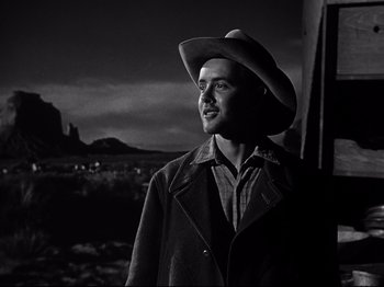 Movie still from “My Darling Clementine” (1946), directed by John Ford – A black and white photo of a man wearing a cowboy hat; Medium shot, Low angle