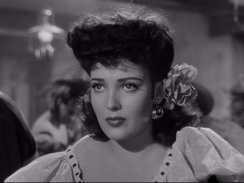 Movie still from “My Darling Clementine” (1946), directed by John Ford – A black and white photo of a woman with a flower in her hair; Close Up shot, Low angle