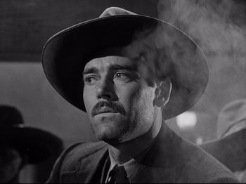 Movie still from “My Darling Clementine” (1946), directed by John Ford – A black and white photo of a man wearing a hat; Close Up shot, Low angle