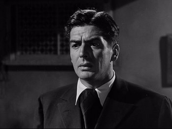 Movie still from “My Darling Clementine” (1946), directed by John Ford – Black and white photograph of a man wearing a suit and tie; Close Up shot, Low angle