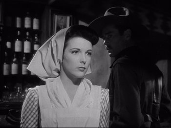 Movie still from “My Darling Clementine” (1946), directed by John Ford – A woman with a hat on her head standing next to a man; Close Up shot, Low angle