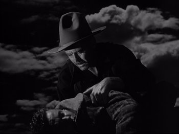 Movie still from “My Darling Clementine” (1946), directed by John Ford – A black and white photo of a man in a hat; Medium shot, Low angle