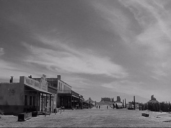 Movie still from “My Darling Clementine” (1946), directed by John Ford – A black and white photo of a street scene; Extreme Wide shot, Low angle