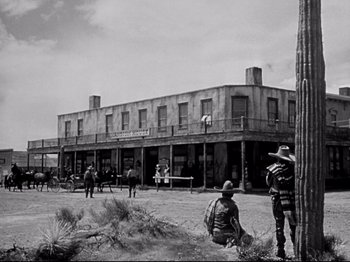 Movie still from “My Darling Clementine” (1946), directed by John Ford – A black and white photo of people standing in front of a building; Wide shot, Low angle