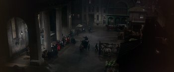 Movie still from “My Fair Lady” (1964), directed by George Cukor – A group of people riding horses in a courtyard at night; Extreme Wide shot, High angle
