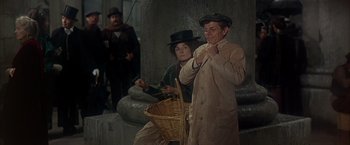 Movie still from “My Fair Lady” (1964), directed by George Cukor – A man and a woman dressed in vintage clothing; Medium shot, Low angle