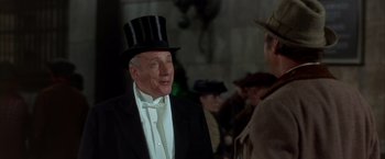 Movie still from “My Fair Lady” (1964), directed by George Cukor – An older man wearing a top hat and a tuxedo; Medium shot, Over the shoulder angle