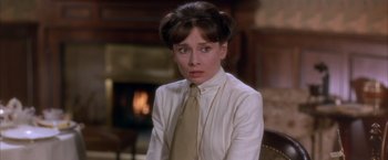 Movie still from “My Fair Lady” (1964), directed by George Cukor – A woman in a white shirt and a yellow neck tie; Close Up shot, Over the shoulder angle