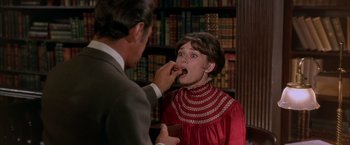 Movie still from “My Fair Lady” (1964), directed by George Cukor – A man feeding a woman a piece of cake; Medium shot, Over the shoulder angle