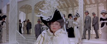 Movie still from “My Fair Lady” (1964), directed by George Cukor – An older woman wearing a black and white hat; Close Up shot, Over the shoulder angle