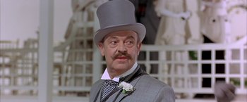 Movie still from “My Fair Lady” (1964), directed by George Cukor – An older man wearing a top hat and a tie; Close Up shot, Low angle