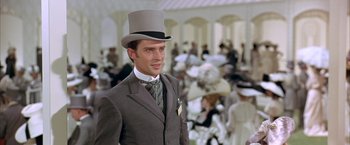 Movie still from “My Fair Lady” (1964), directed by George Cukor – A man wearing a top hat and a suit; Medium shot, Low angle