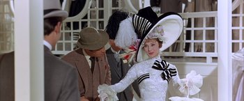 Movie still from “My Fair Lady” (1964), directed by George Cukor – A man and a woman dressed up in costumes; Medium shot, Over the shoulder angle