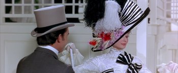 Movie still from “My Fair Lady” (1964), directed by George Cukor – A man and a woman wearing hats and holding a cane; Close Up shot, Over the shoulder angle