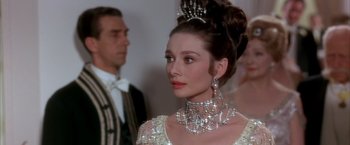 Movie still from “My Fair Lady” (1964), directed by George Cukor – A person wearing a dress and a tiara; Close Up shot, Over the shoulder angle