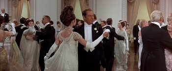 Movie still from “My Fair Lady” (1964), directed by George Cukor – A man and a woman in formal wear dancing; Medium shot, Low angle