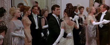 Movie still from “My Fair Lady” (1964), directed by George Cukor – A man and a woman dressed in formal wear; Medium shot, Low angle