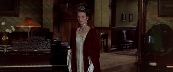 Movie still from “My Fair Lady” (1964), directed by George Cukor – A woman in a white dress and a red coat; Medium shot, Low angle