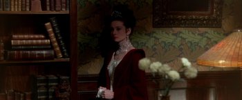 Movie still from “My Fair Lady” (1964), directed by George Cukor – A woman wearing a tiara and a red robe; Medium shot, High angle