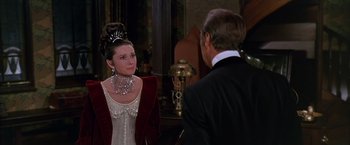 Movie still from “My Fair Lady” (1964), directed by George Cukor – A woman in a white dress talking to a man in a black suit; Medium shot, Over the shoulder angle