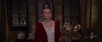 Movie still from “My Fair Lady” (1964), directed by George Cukor – A woman wearing a tiara and a red jacket; Close Up shot, Low angle