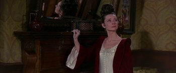 Movie still from “My Fair Lady” (1964), directed by George Cukor – A woman holding a mirror in front of a mirror; Medium shot, Over the shoulder angle