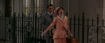 Movie still from “My Fair Lady” (1964), directed by George Cukor – A man and a woman dressed in vintage clothing; Medium shot, High angle