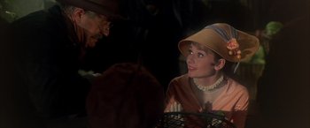 Movie still from “My Fair Lady” (1964), directed by George Cukor – An older man and a young woman talking to each other; Close Up shot, Over the shoulder angle