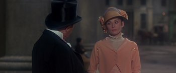 Movie still from “My Fair Lady” (1964), directed by George Cukor – A man and a woman standing next to each other; Medium shot, Over the shoulder angle