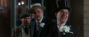 Movie still from “My Fair Lady” (1964), directed by George Cukor – A group of men in suits and top hats standing next to each other; Close Up shot, Low angle