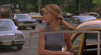 Movie still from “My Father the Hero” (1994), directed by Steve Miner – A woman with long blonde hair standing next to a car; Medium shot, Low angle