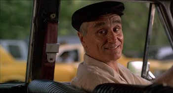 Movie still from “My Father the Hero” (1994), directed by Steve Miner – An older man wearing a hat sitting in the back of a car; Close Up shot, Low angle