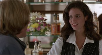 Movie still from “My Father the Hero” (1994), directed by Steve Miner – A woman sitting at a bar talking to a man; Close Up shot, Over the shoulder angle