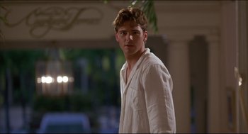 Movie still from “My Father the Hero” (1994), directed by Steve Miner – A young man in a white shirt is looking at the camera; Medium shot, Over the shoulder angle
