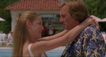 Movie still from “My Father the Hero” (1994), directed by Steve Miner – A man and a woman standing next to each other near a swimming pool; Close Up shot, Low angle